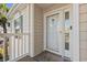 Close-up of a welcoming front door with a decorative glass insert and stylish welcome mat at 4929 Pond Shoals Ct. # 201, Myrtle Beach, SC 29579