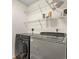 Functional laundry room with modern washer and dryer units, and wire shelving at 4929 Pond Shoals Ct. # 201, Myrtle Beach, SC 29579