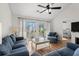 Spacious living room featuring hardwood floors and a sliding glass door leading to a private balcony at 4929 Pond Shoals Ct. # 201, Myrtle Beach, SC 29579