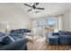 Cozy living room with comfortable seating, wood floors, and a sliding glass door to a balcony at 4929 Pond Shoals Ct. # 201, Myrtle Beach, SC 29579