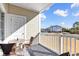 Scenic balcony view with outdoor seating, white railings, and exterior storage at 5801 Oyster Catcher Dr. # 822, North Myrtle Beach, SC 29582