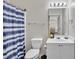 Clean bathroom features a shower/tub, white sink and vanity, with a striped shower curtain at 5801 Oyster Catcher Dr. # 822, North Myrtle Beach, SC 29582