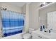 Bright bathroom features a shower/tub, white sink and vanity with blue striped shower curtain at 5801 Oyster Catcher Dr. # 822, North Myrtle Beach, SC 29582