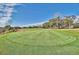 Scenic view of the meticulously maintained green on the golf course with lush trees and clear blue skies at 5801 Oyster Catcher Dr. # 822, North Myrtle Beach, SC 29582