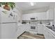 Well-lit kitchen with all-white appliances and cabinets and modern hardware, with an archway feature at 5801 Oyster Catcher Dr. # 822, North Myrtle Beach, SC 29582
