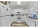 Bright kitchen featuring white cabinets, countertops, and appliances, with a window over the sink at 5801 Oyster Catcher Dr. # 822, North Myrtle Beach, SC 29582