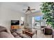 Comfortable living room with wood flooring and a sliding glass door leading to a private patio at 5801 Oyster Catcher Dr. # 822, North Myrtle Beach, SC 29582