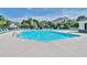 Large outdoor community pool surrounded by lounge chairs and lush landscaping at 5801 Oyster Catcher Dr. # 822, North Myrtle Beach, SC 29582