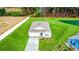 Aerial view of a charming home with a manicured lawn, fenced yard, pond, and scenic surroundings at 519 Grass Fern Ct., Longs, SC 29568