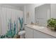 Well-lit bathroom with charming cactus-themed shower curtain and stylish decor at 519 Grass Fern Ct., Longs, SC 29568
