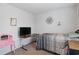 This is a bedroom with a comfortable space with a television and vanity at 519 Grass Fern Ct., Longs, SC 29568