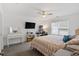 Bright bedroom with lots of furniture, a ceiling fan, and two windows providing lots of light at 519 Grass Fern Ct., Longs, SC 29568