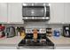 Close up on stainless oven and microwave against neutral backsplash and countertop with small appliances at 519 Grass Fern Ct., Longs, SC 29568