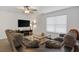 Comfortable living room includes a ceiling fan, mounted TV, and stylish decor at 519 Grass Fern Ct., Longs, SC 29568