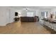 Spacious living room boasts stylish floors, a modern ceiling fan, and access to the kitchen at 519 Grass Fern Ct., Longs, SC 29568