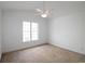 This bedroom features a ceiling fan, carpet and a large window allowing for natural light at 528 Banks Dr. # 2-4 & 2-4G, Myrtle Beach, SC 29588