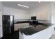 Modern kitchen with white cabinets, black appliances, and sleek countertops at 528 Banks Dr. # 2-4 & 2-4G, Myrtle Beach, SC 29588