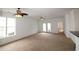 Bright living room boasts large windows, ceiling fan, and access to outdoor area at 528 Banks Dr. # 2-4 & 2-4G, Myrtle Beach, SC 29588