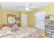 Cozy bedroom features a ceiling fan, cheerful yellow walls and a floral bedspread at 6001-1086 S Kings Hwy., Myrtle Beach, SC 29575