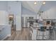 Bright kitchen with white cabinets, stainless steel appliances, and a counter with bar stools at 6001-1086 S Kings Hwy., Myrtle Beach, SC 29575