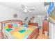 Spacious main bedroom with bright, colorful bedspread, fan and television at 6001-1086 S Kings Hwy., Myrtle Beach, SC 29575