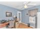 A well-lit office space with light blue walls, a ceiling fan and warm wood-look floors at 6001-1086 S Kings Hwy., Myrtle Beach, SC 29575