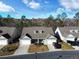 Aerial view of a residential property displaying the home's layout and surrounding neighborhood with mature trees at 662 Sunnyside Dr. # 101, Murrells Inlet, SC 29576