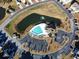 Birds-eye view of the community pool, pond, ample parking, and surrounding greenery, a great community feature at 662 Sunnyside Dr. # 101, Murrells Inlet, SC 29576