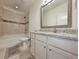 Bright bathroom with granite counters, white cabinets, and tiled tub-shower at 662 Sunnyside Dr. # 101, Murrells Inlet, SC 29576