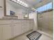 Bright bathroom features double vanity with granite counters and walk-in shower at 662 Sunnyside Dr. # 101, Murrells Inlet, SC 29576