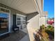 Inviting front porch featuring a chair, accent table, and manicured landscaping, creating a welcoming entrance at 662 Sunnyside Dr. # 101, Murrells Inlet, SC 29576