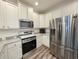Updated kitchen featuring stainless steel appliances, granite countertops, and custom white cabinetry, designed for style at 662 Sunnyside Dr. # 101, Murrells Inlet, SC 29576