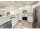 Modern kitchen with stainless steel appliances, granite countertops, and white cabinets, providing a stylish cooking space at 662 Sunnyside Dr. # 101, Murrells Inlet, SC 29576
