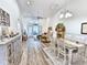 Open-concept living area with modern furnishings, light wood floors and lots of natural light at 662 Sunnyside Dr. # 101, Murrells Inlet, SC 29576