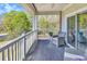 Relaxing covered balcony featuring outdoor seating and views of the surrounding greenery at 670 Riverwalk Dr. # 304, Myrtle Beach, SC 29579