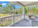 Covered balcony with seating, overlooking a lush green lawn and treeline at 670 Riverwalk Dr. # 304, Myrtle Beach, SC 29579