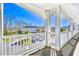 Wide balcony with white railings overlooking parking lot and adjacent building under a clear blue sky at 670 Riverwalk Dr. # 304, Myrtle Beach, SC 29579