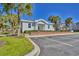 Exterior view of the clubhouse, with a brick foundation, palm trees and dedicated parking spaces at 670 Riverwalk Dr. # 304, Myrtle Beach, SC 29579