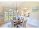 Bright dining area with large windows offering great natural light open to the kitchen with stainless steel appliances at 670 Riverwalk Dr. # 304, Myrtle Beach, SC 29579
