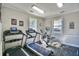 Well-equipped gym with modern exercise equipment and plenty of natural light from the two windows, making fitness convenient and enjoyable at 670 Riverwalk Dr. # 304, Myrtle Beach, SC 29579