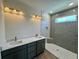Modern bathroom features a double vanity, marble countertop, and a walk-in shower with tile surround and pebble floor at 713 9Th Ave. S, North Myrtle Beach, SC 29582