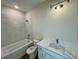 Bright bathroom with a combined bathtub/shower, white cabinetry and a marble countertop sink at 713 9Th Ave. S, North Myrtle Beach, SC 29582