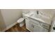 Powder room featuring a modern vanity with a white countertop and white cabinets next to a toilet at 713 9Th Ave. S, North Myrtle Beach, SC 29582