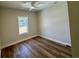 Simple bedroom with hardwood floors, a ceiling fan, and a window allowing natural light at 713 9Th Ave. S, North Myrtle Beach, SC 29582
