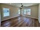 Light-filled bedroom with three windows, luxury vinyl plank flooring, and neutral paint creating a tranquil atmosphere at 713 9Th Ave. S, North Myrtle Beach, SC 29582