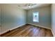 Cozy bedroom with hardwood floors, a ceiling fan, and a window letting in natural light at 713 9Th Ave. S, North Myrtle Beach, SC 29582