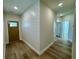 Inviting entryway with hardwood floors, shiplap accent wall, and a view of a door leading into another room at 713 9Th Ave. S, North Myrtle Beach, SC 29582