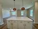 Open-concept kitchen island featuring marble countertops and pendant lighting adjacent to a large open living area at 713 9Th Ave. S, North Myrtle Beach, SC 29582