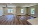 Open-concept living room with a shiplap wall, luxury vinyl plank flooring, and abundant natural light at 713 9Th Ave. S, North Myrtle Beach, SC 29582