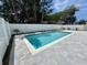 Backyard pool with patio and a white privacy fence surrounded by greenery at 713 9Th Ave. S, North Myrtle Beach, SC 29582